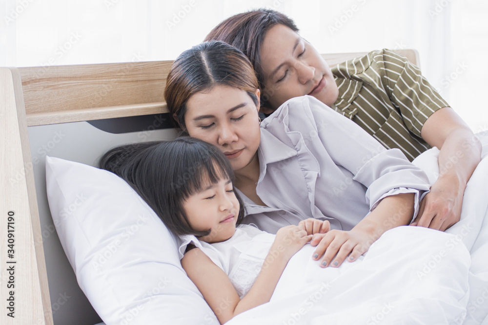 Asian family is sleeping on the bed Asian family is sleeping on the bed