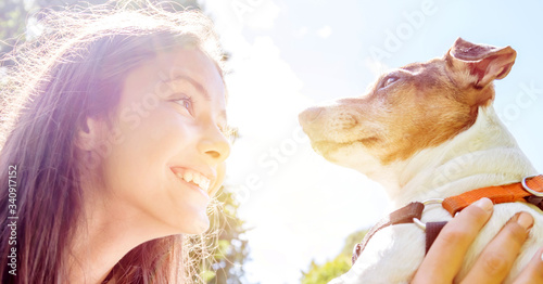 Fotografie teen girl and her dog look at each other with love and smile
