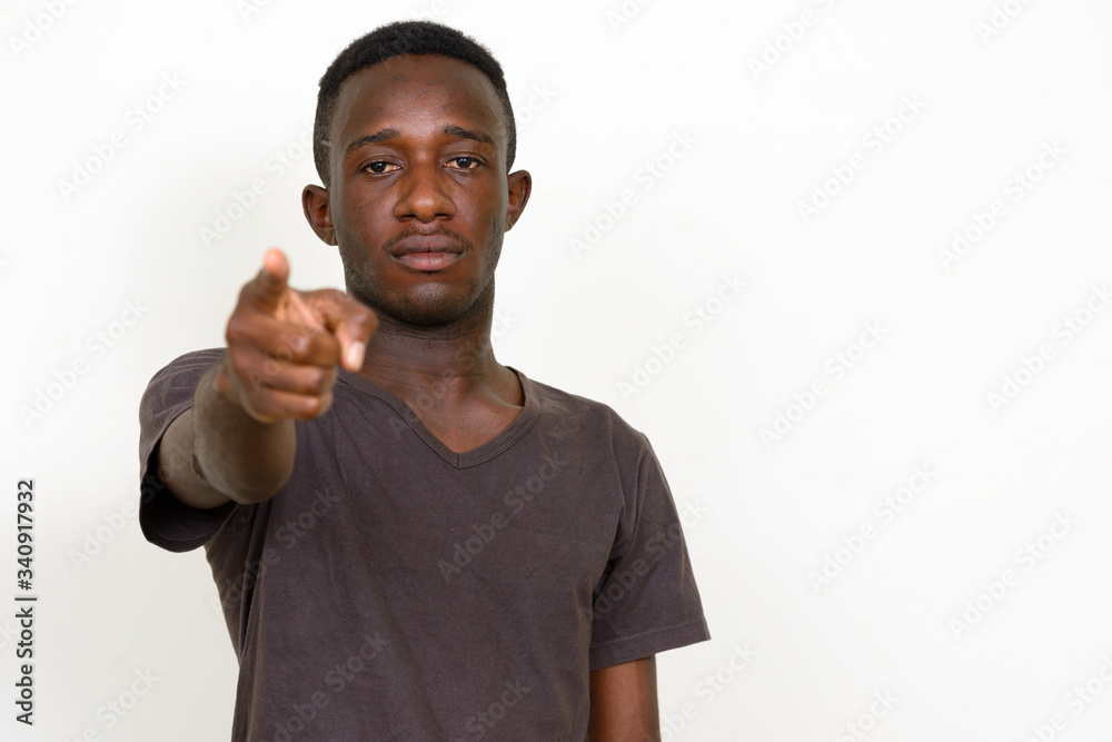Portrait of young African man pointing at camera Portrait of young African man pointing at camera