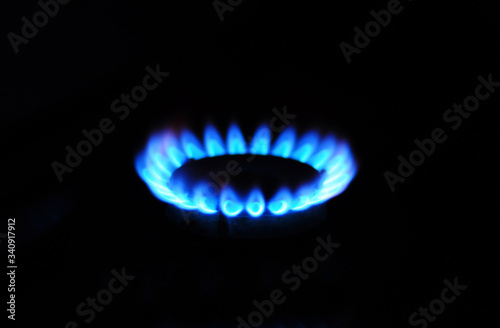 A close up on natural gas blue fire, stove burner, gas burner lighting.