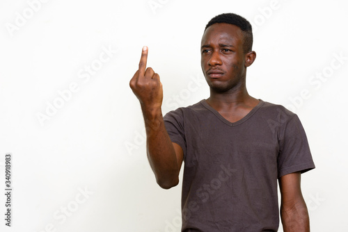 Konstfotografi Portrait of stressed young African man showing middle finger
