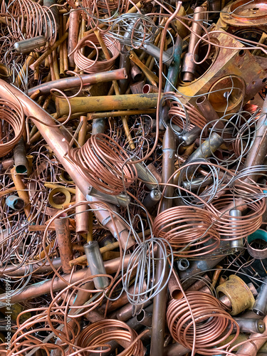 Copper scrap tubes and wire ready to be recycled, portrait view 