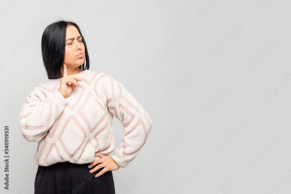 Portrait of a beautiful woman thinking female students looking up at a blank bubble isolated on gray background Portrait of a beautiful woman thinking female students looking up at a blank bubble isolated on gray background