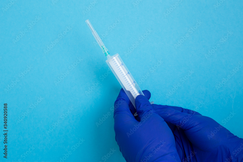 hand with syringe isolated on blue, hand in blue latex gloves, coronavirus, illness, infection, quarantine, hand with syringe isolated on blue, hand in blue latex gloves, coronavirus, illness, infection, quarantine,