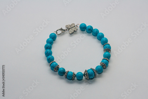 Turquoise bracelet on white background. Female accessories, decorative ornaments and jewelry. Fashion and style concept.