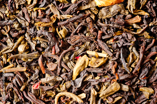 A mixture of black and green tea with vanilla-strawberry flavor, sliced strawberries and rose petals. Background for tea and antioxidants.