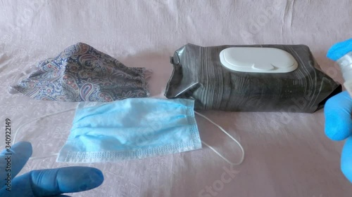 A man in protective gloves shows disinfectants wipes, sanitizer, protective masks during the KOVID-19 pandemic