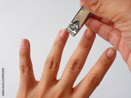 The left fingernail is cut by a nail clippers. The fingernails  harbor dirt and germs and can contribute to the spread of some infections nail, so that the grooming is a important self-care routine.