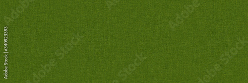 Close-up long and wide texture of natural green fabric or cloth in green yellow color. Fabric texture of natural cotton or linen textile material. Green canvas background.
