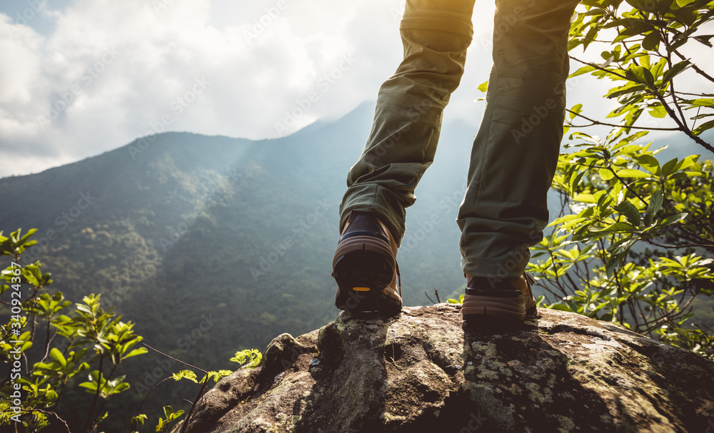 Successful hiker enjoy the view on mountain top cliff edge Successful hiker enjoy the view on mountain top cliff edge