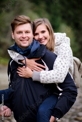 Man giving piggyback ride to girlfriend, having fun.