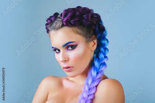 Beautiful woman with long hair. Modern french braid, in a beauty salon. Professional hair care and creating hairstyles. Kanekalon strand in braids. photo