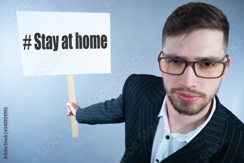A man holds a sign with the...