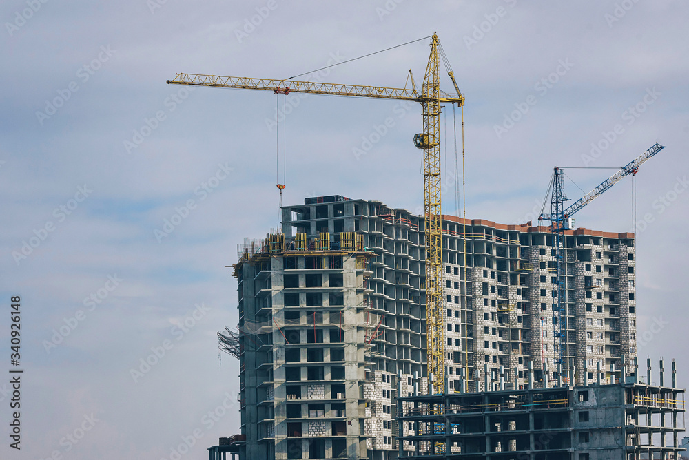 construction of a new high-rise multi-storey building for a large number of apartments. two tower cranes are working at the construction site