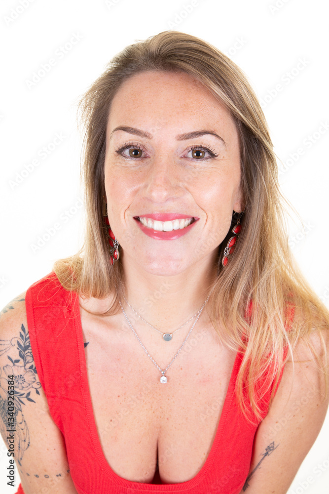 Smiling tatoo young woman blonde on white wall background Smiling tatoo young woman blonde on white wall background