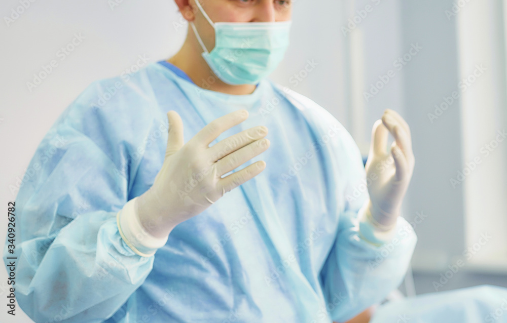 Several doctors surrounding patient on operation table during their work. Team surgeons at work in operating room Several doctors surrounding patient on operation table during their work. Team surgeons at work in operating room