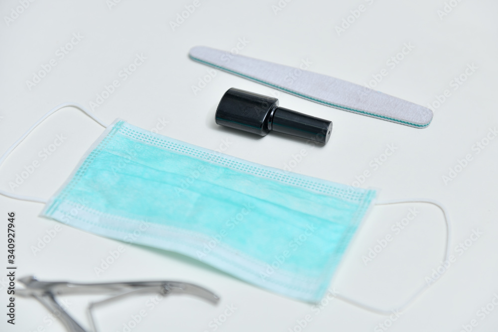 Gel polish, medical mask, manicure scissors, nail file, coronavirus concept. Collage manicure set with coronavirus, 2019-nCoV. Gel polish and coronavirus, COVID-19, 2019-nCoV. Gel polish, medical mask, manicure scissors, nail file, coronavirus concept. Collage manicure set with coronavirus, 2019-nCoV. Gel polish and coronavirus, COVID-19, 2019-nCoV.
