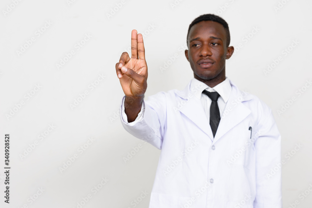 Portrait of young African man doctor touching something Portrait of young African man doctor touching something