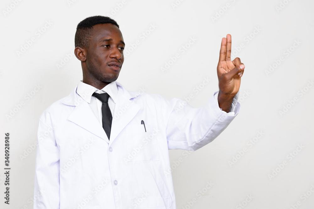 Portrait of young African man doctor touching something Portrait of young African man doctor touching something