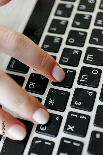 Woman is typing on laptop, female hands are typing on keys