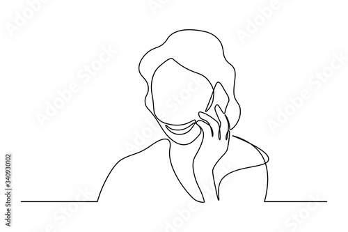 Woman talking on mobile phone in continuous line art drawing style. Minimalist black linear sketch isolated on white background. Vector illustration