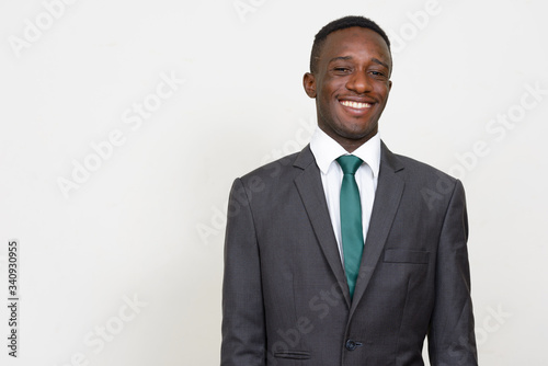 Portrait of happy young African businessman in suit smiling