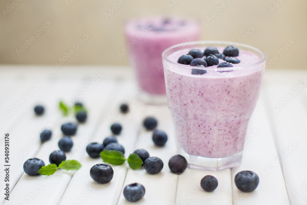 Healthy breakfast of smoothie, dessert, yogurt or milkshake with fresh berries on whtite wooden table Healthy breakfast of smoothie, dessert, yogurt or milkshake with fresh berries on whtite wooden table