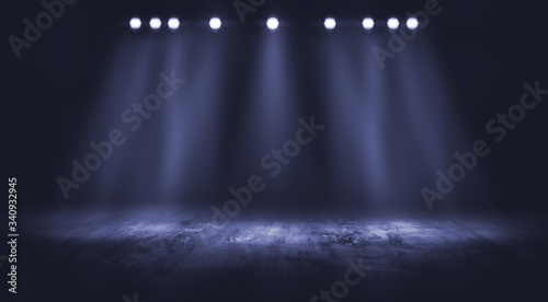 Dark stage with spotlight background.