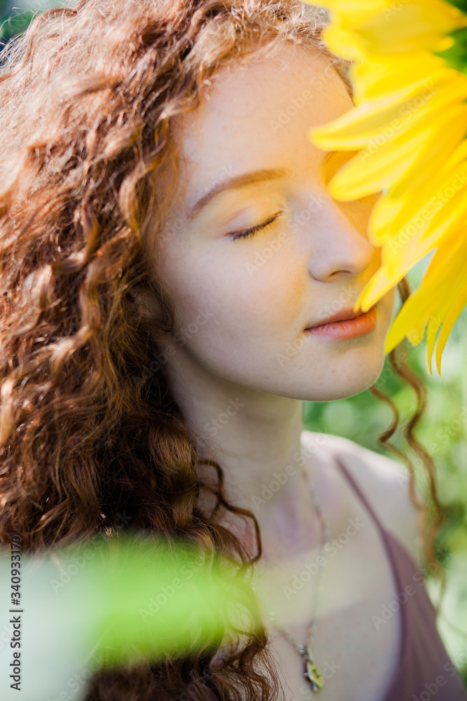 The red hair girl in sunflowers field The red hair girl in sunflowers field