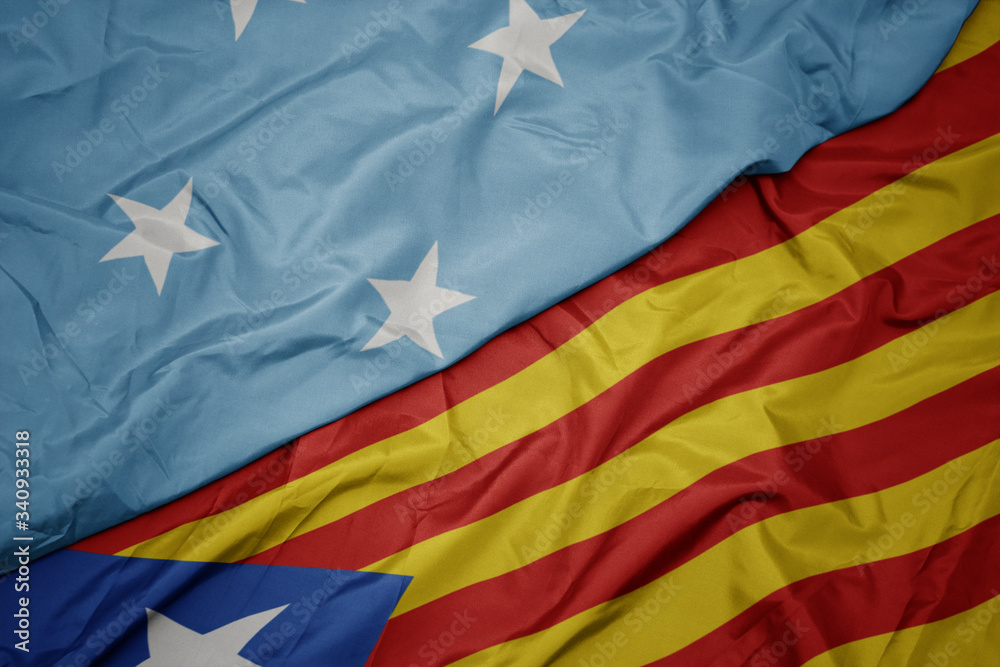 Fototapeta premium waving colorful flag of catalonia and national flag of Federated States of Micronesia .