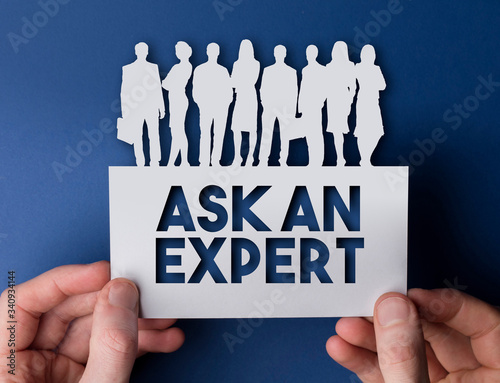 Hands holding an ask an expert white card business team people sign photo