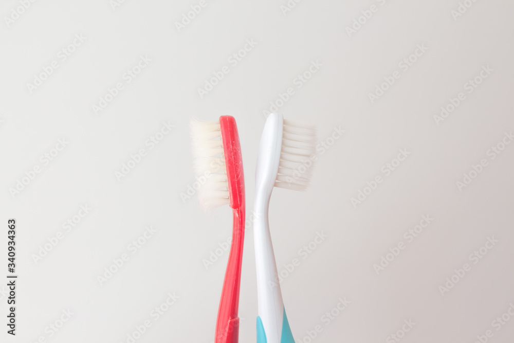 Red and blue toothbrushes on a gray background. Old and new toothbrush. Oral hygiene concept. copy space for text Red and blue toothbrushes on a gray background. Old and new toothbrush. Oral hygiene concept. copy space for text