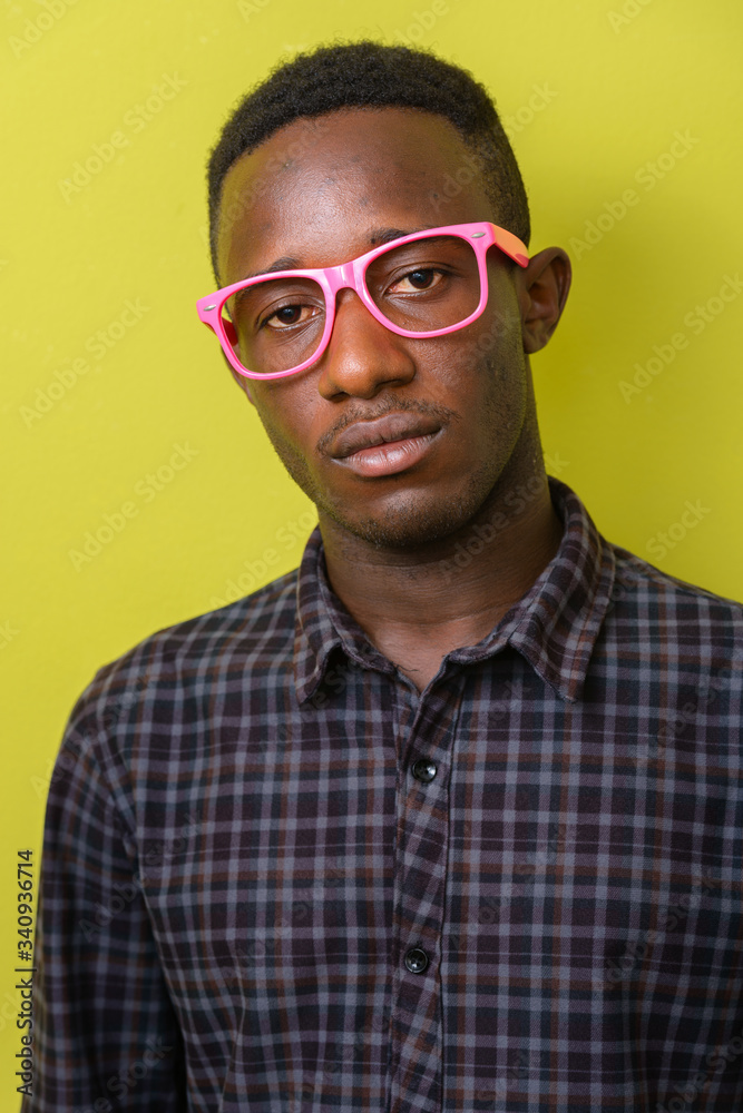 Obraz premium Face of young African hipster man with eyeglasses