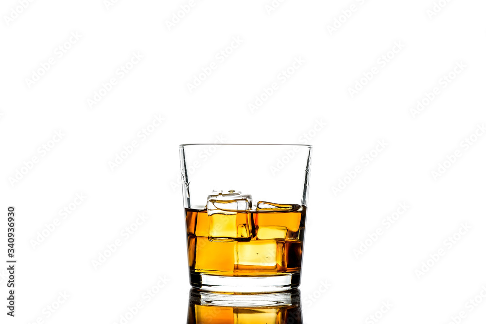 Whiskey with ice cubes.Isolated shot of whiskey.Glass of scotch and ice cubes on a white background. Whiskey with ice cubes.Isolated shot of whiskey.Glass of scotch and ice cubes on a white background.
