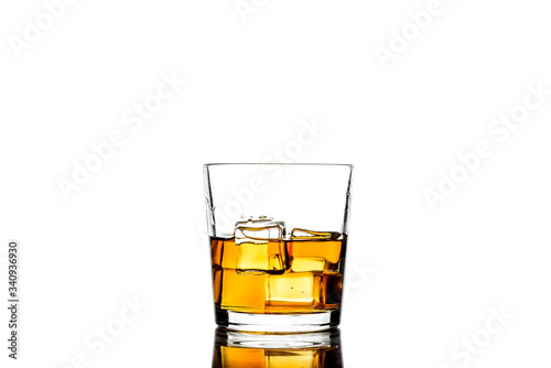 Whiskey with ice cubes.Isolated shot of whiskey.Glass of scotch and ice cubes on a white background.