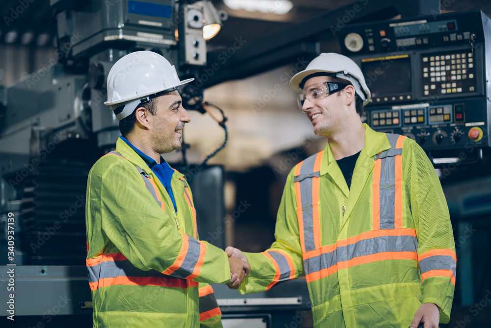 professional technician engineer shake hand with Operator Operating Industrial in factory professional technician engineer shake hand with Operator Operating Industrial in factory