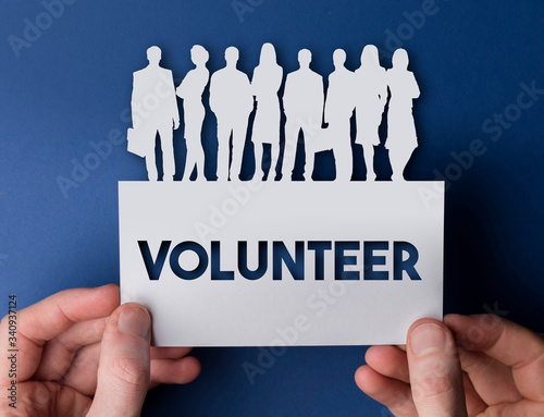 Hands holding a volunteer white card business team people sign