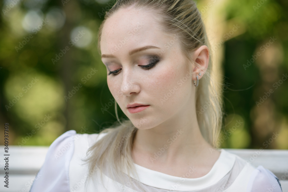 Outdoors portrait of beautiful young woman in the park. Selective focus. Outdoors portrait of beautiful young woman in the park. Selective focus.