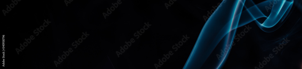 Naklejka premium Blue smoke on black background