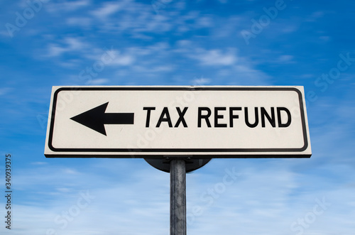 Tax refund road sign, arrow on blue sky background. One way blank road sign with copy space. Arrow on a pole pointing in one direction.