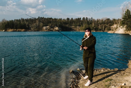 Self-isolation in nature, protection, coronavirus. We won COVID-19. Fisherman, rod, spinning reel on lake bank. Fishing for pike, perch, carp on pond. Quarantine concept in countryside, rural getaway.