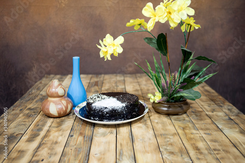 Moisture cake with topping chocolate, dry coconut with decoration on the wooden table, selective focus. photo