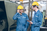 profession technician engineer and Apprentice operate heavy machine to automated CNC in factory