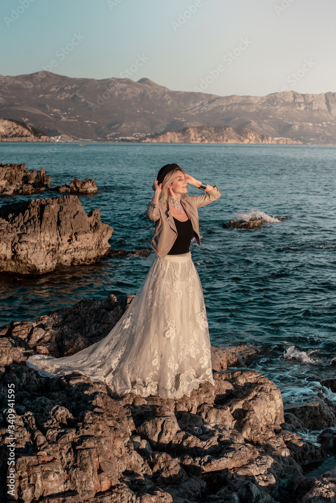 Woman on the sea in white long dress Woman on the sea in white long dress