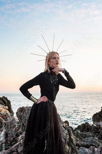 young girlon the sea in a black long dress photo