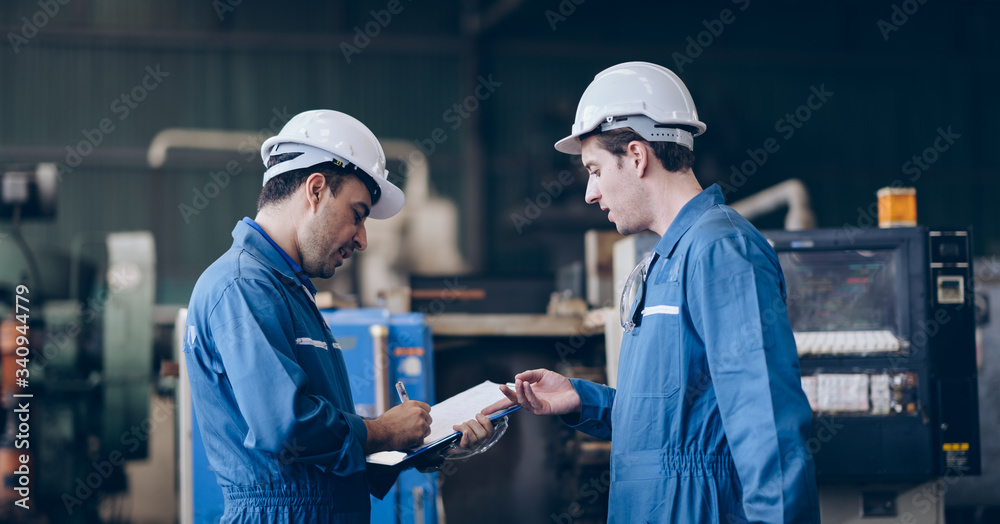 professional technician engineer discussion on document paper in factory
