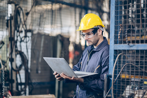 technician engineer checking process on laptop in factory
