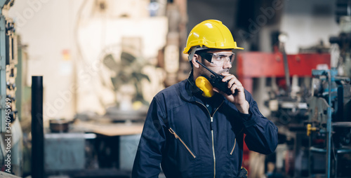 engineers inspector using walkie talkie to command in factory
