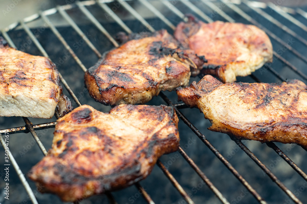 Steak ribi black angus grilled stripes smoke steam charcoal frying. Big raw piece of meat from beef to black metal lattice for frying Steak ribi black angus grilled stripes smoke steam charcoal frying. Big raw piece of meat from beef to black metal lattice for frying