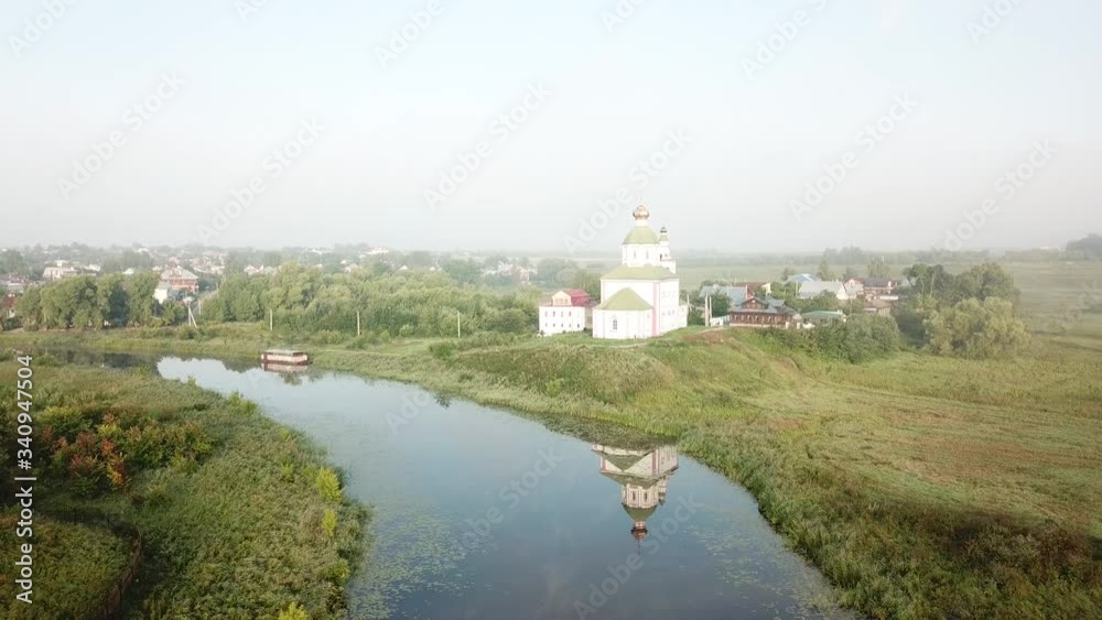 4K aerial dense foggy summer morning video of Suzdal churches, buildings, hills, fields and cathedrals located on Kamenka River shore in Vladimir Region, Russia 4K aerial dense foggy summer morning video of Suzdal churches, buildings, hills, fields and cathedrals located on Kamenka River shore in Vladimir Region, Russia